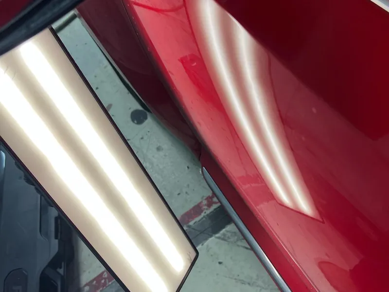 A red door panel under the dent light