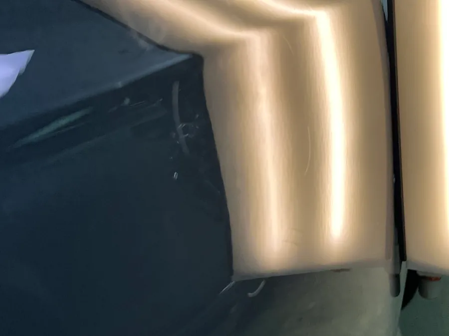 A grey door with the light board reflected